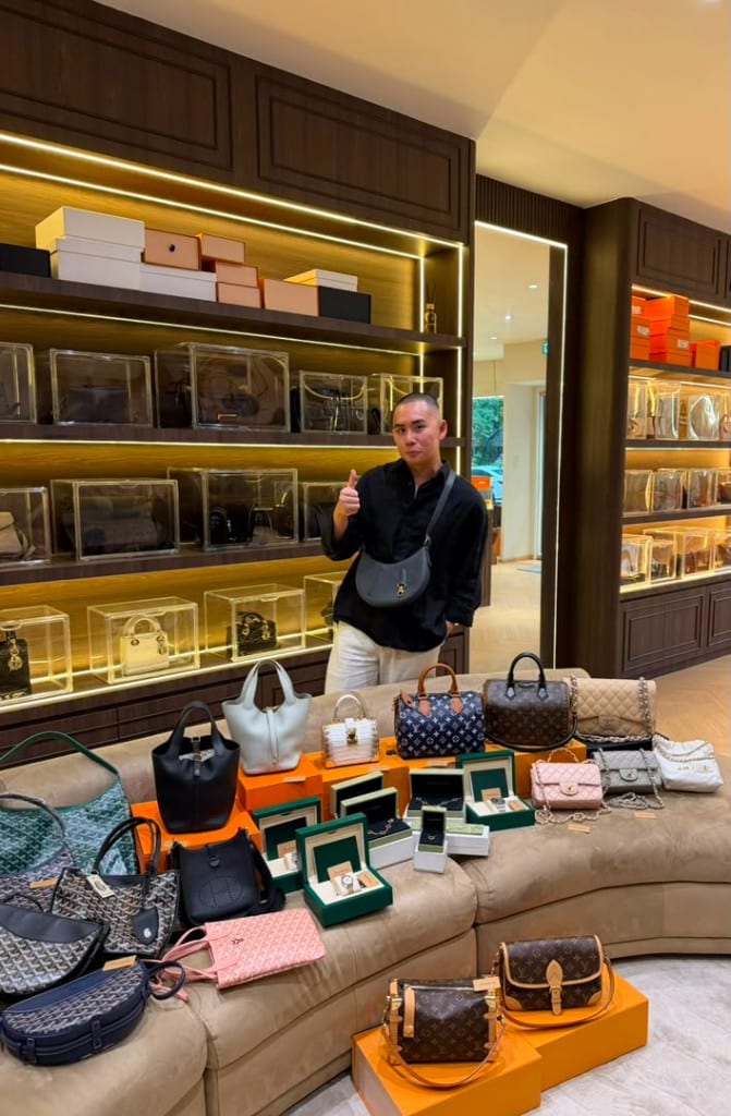 LOWEELUXURY showroom consultant with luxury bags and watches display